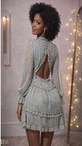 A Green Floral Mini Dress With A V-neck, Long Sleeves, A Shirred Waist, And Ruffled Tiers