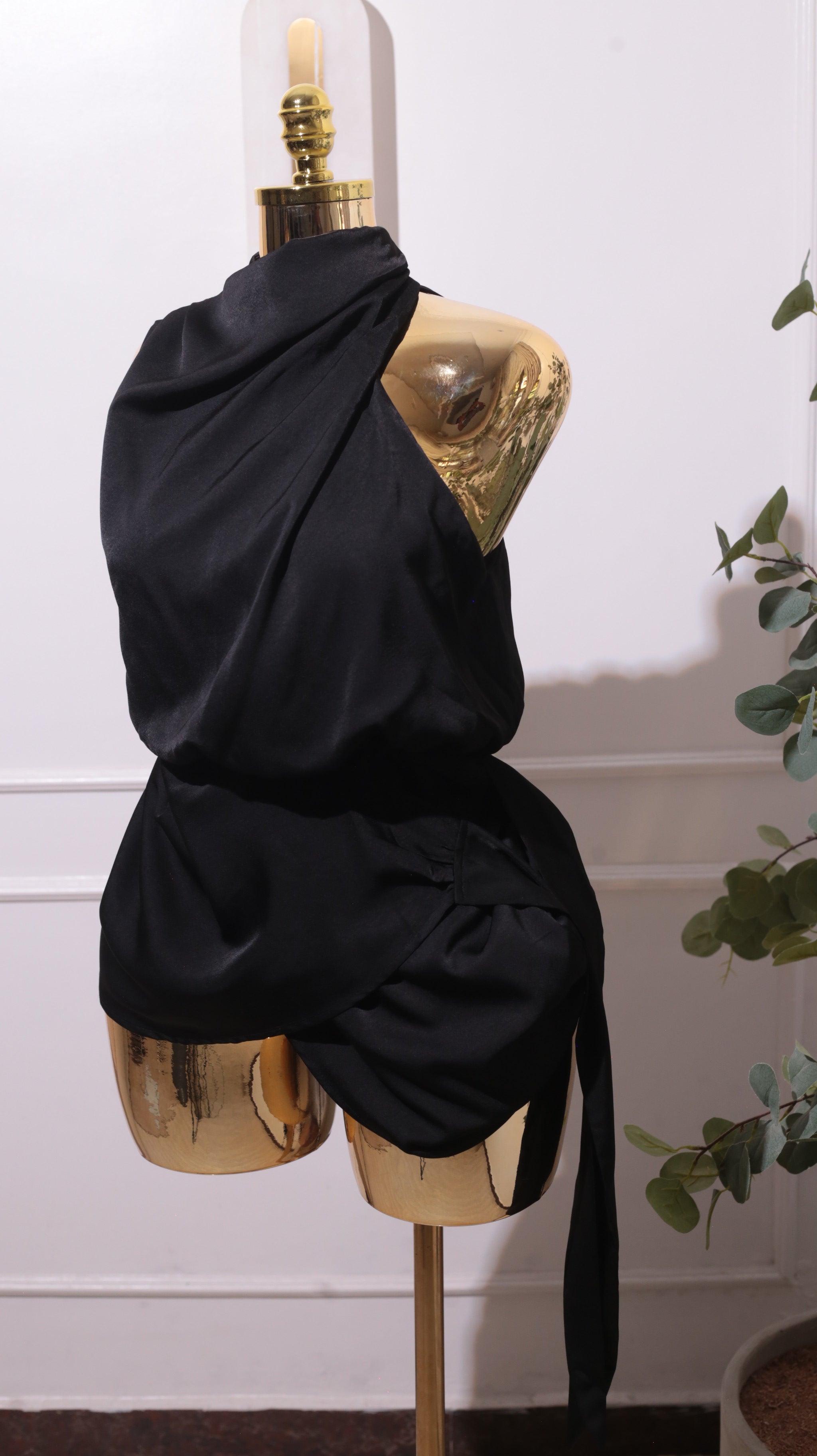 A Black Halter-neck Mini Dress With A Draped Neckline And A Waist Tie Detail