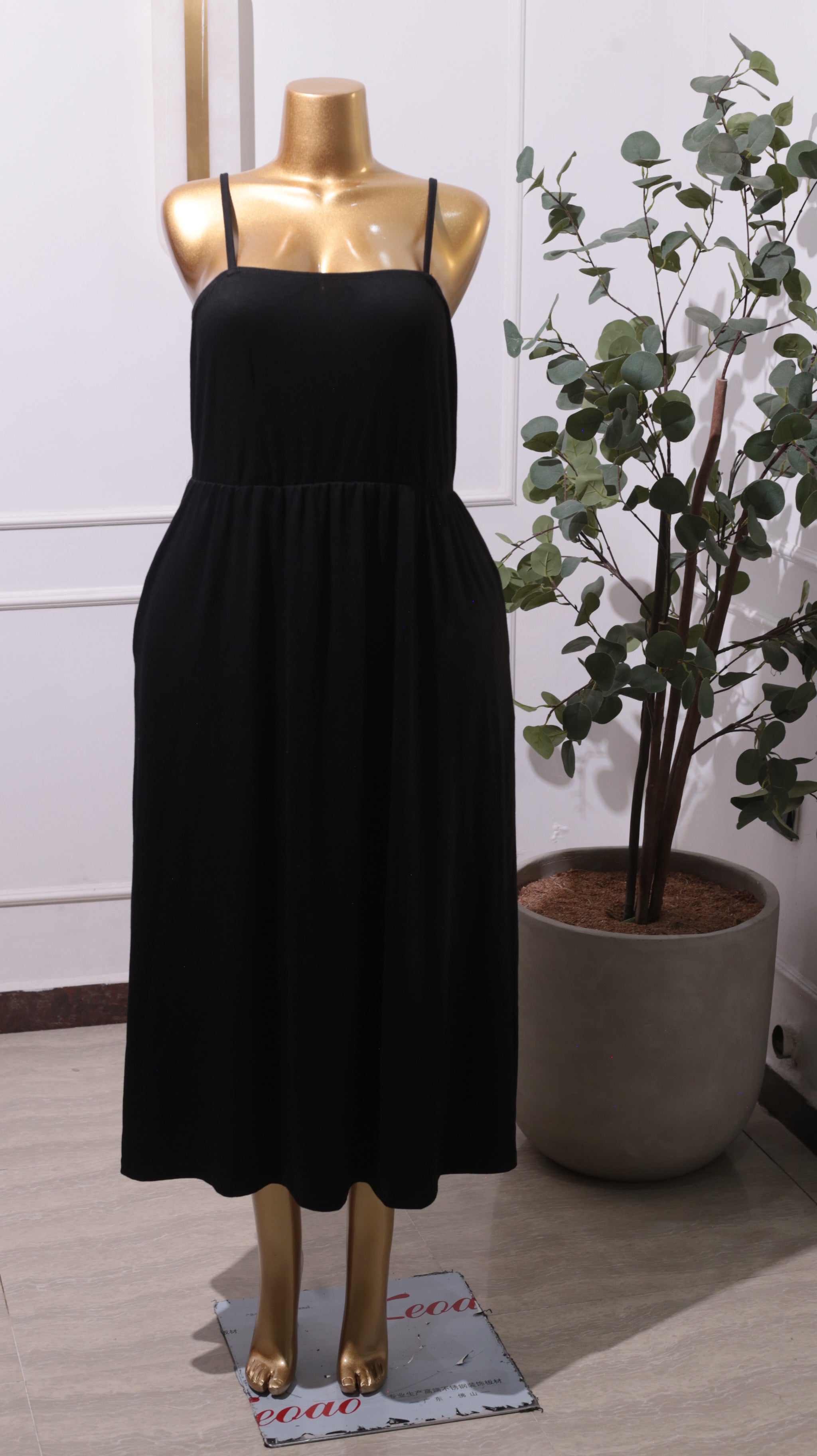 A Black Smocked Bodice Midi Dress With Adjustable Spaghetti Straps