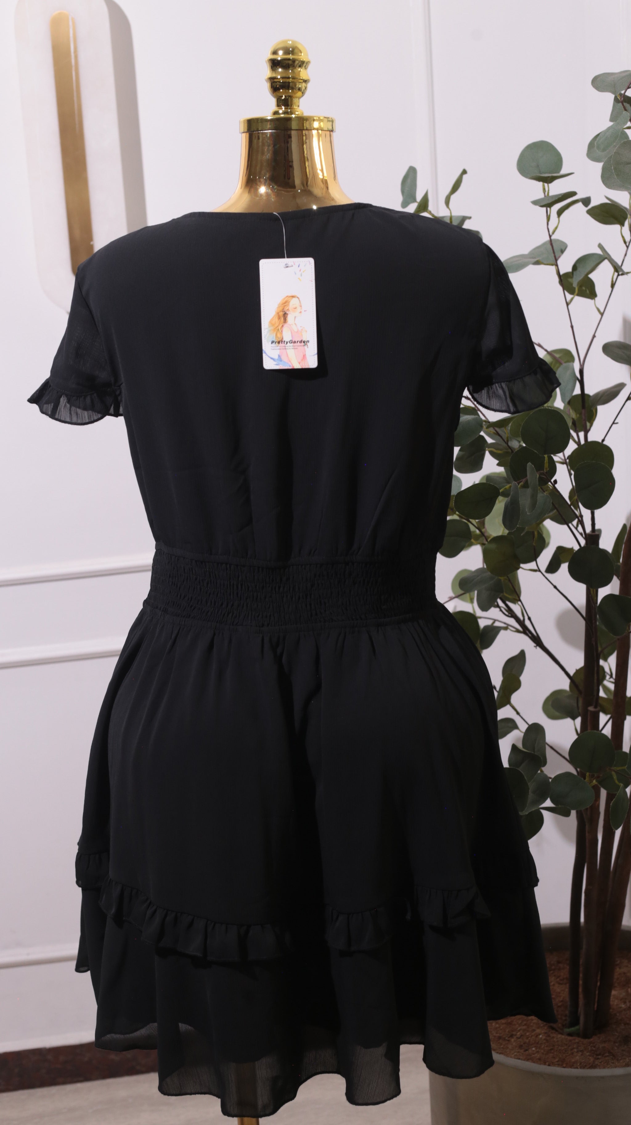 A Black Mini Dress With A Smocked Stretchy Waist And Tiered Ruffles