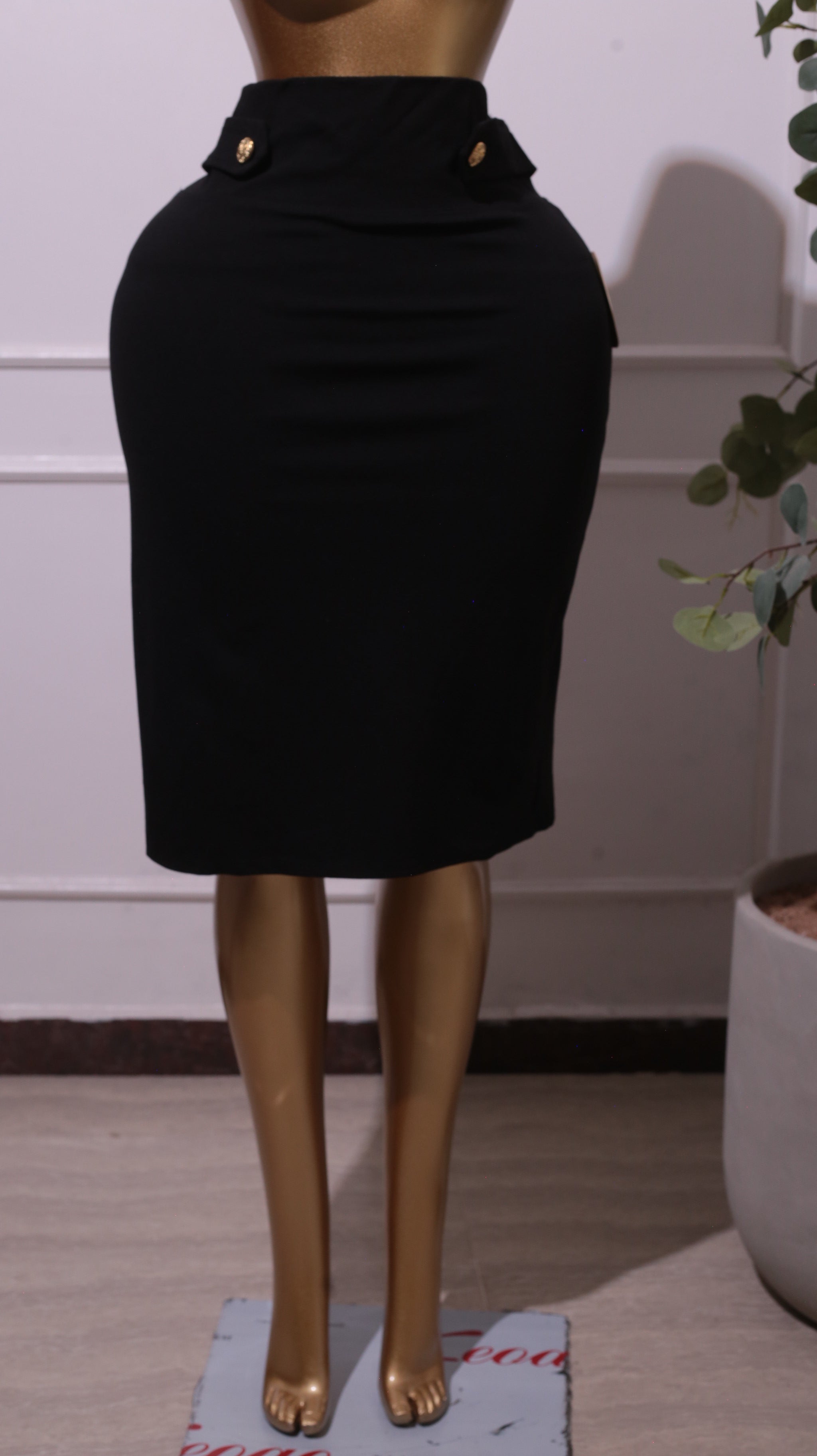 A Black Pencil Skirt With Gold Button Details