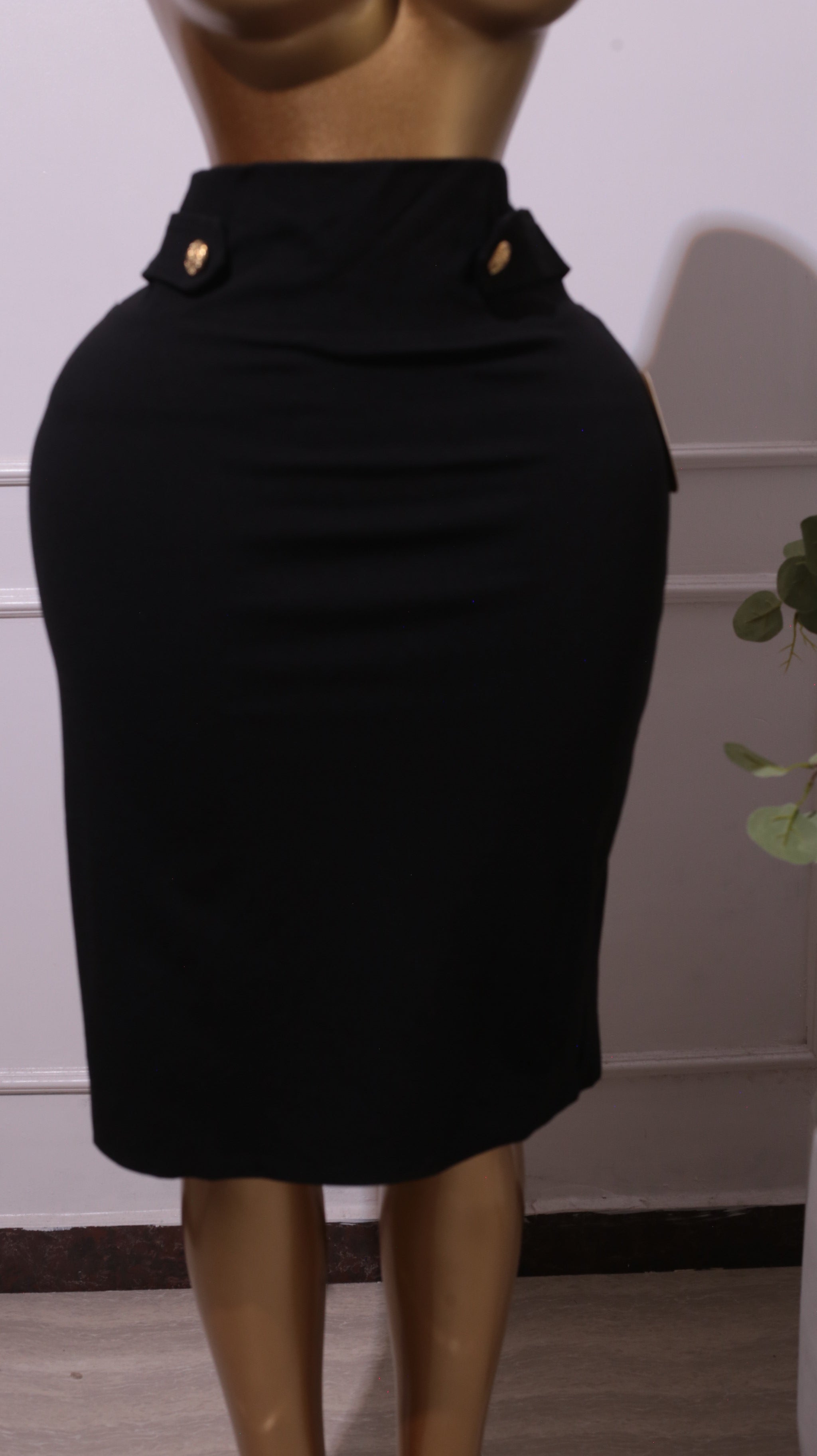 A Black Pencil Skirt With Gold Button Details