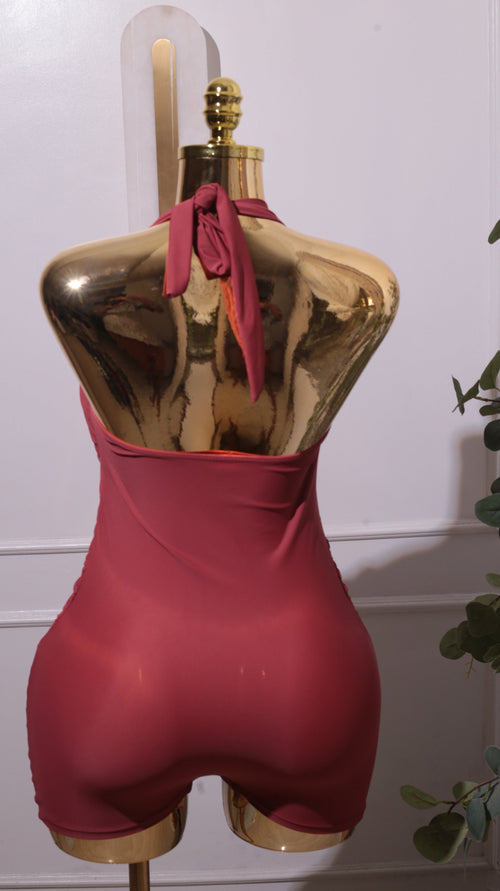 A Draped Halter Swimsuit In A Reddish-brown Or Rust Color