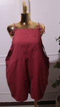 A Pair Of Women's Loose-fit Cotton Overalls Or Romper In A Reddish-brown Color, Featuring Adjustable Shoulder Straps, A