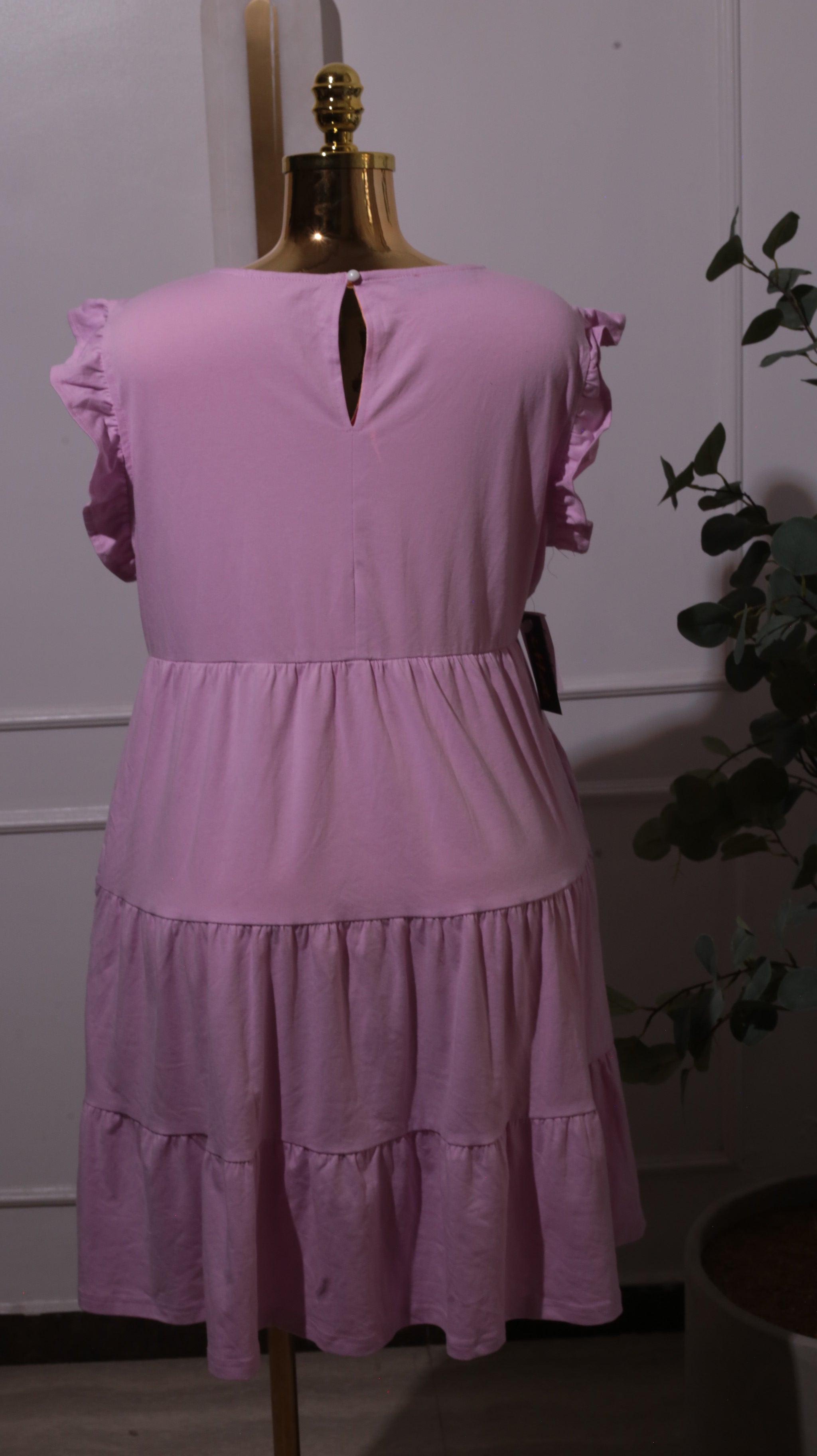 A Pink Tiered Dress With Ruffle Cap Sleeves