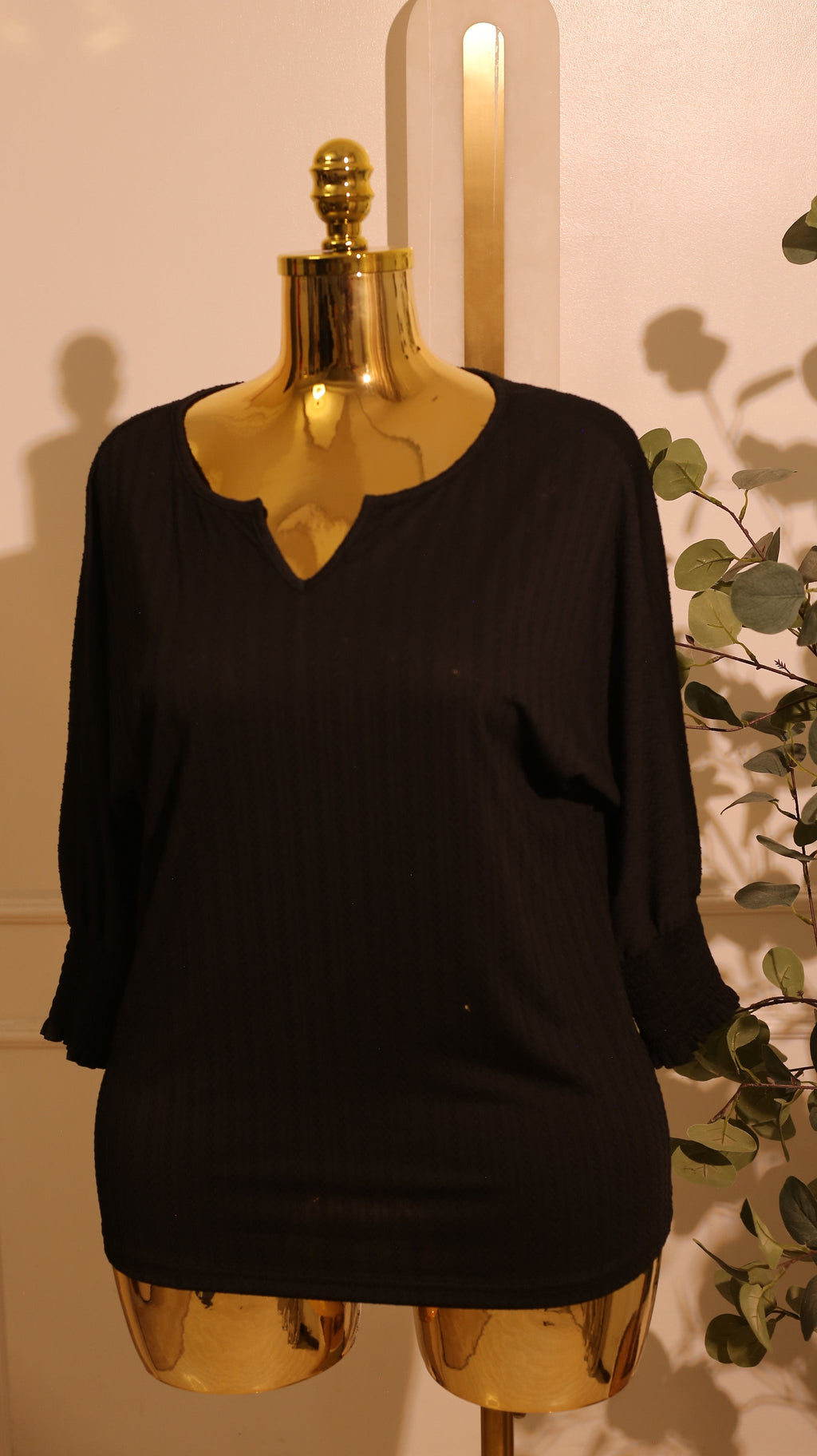 Black, Short-Sleeved Blouse With A V-Neck And A Textured, Vertical Pattern