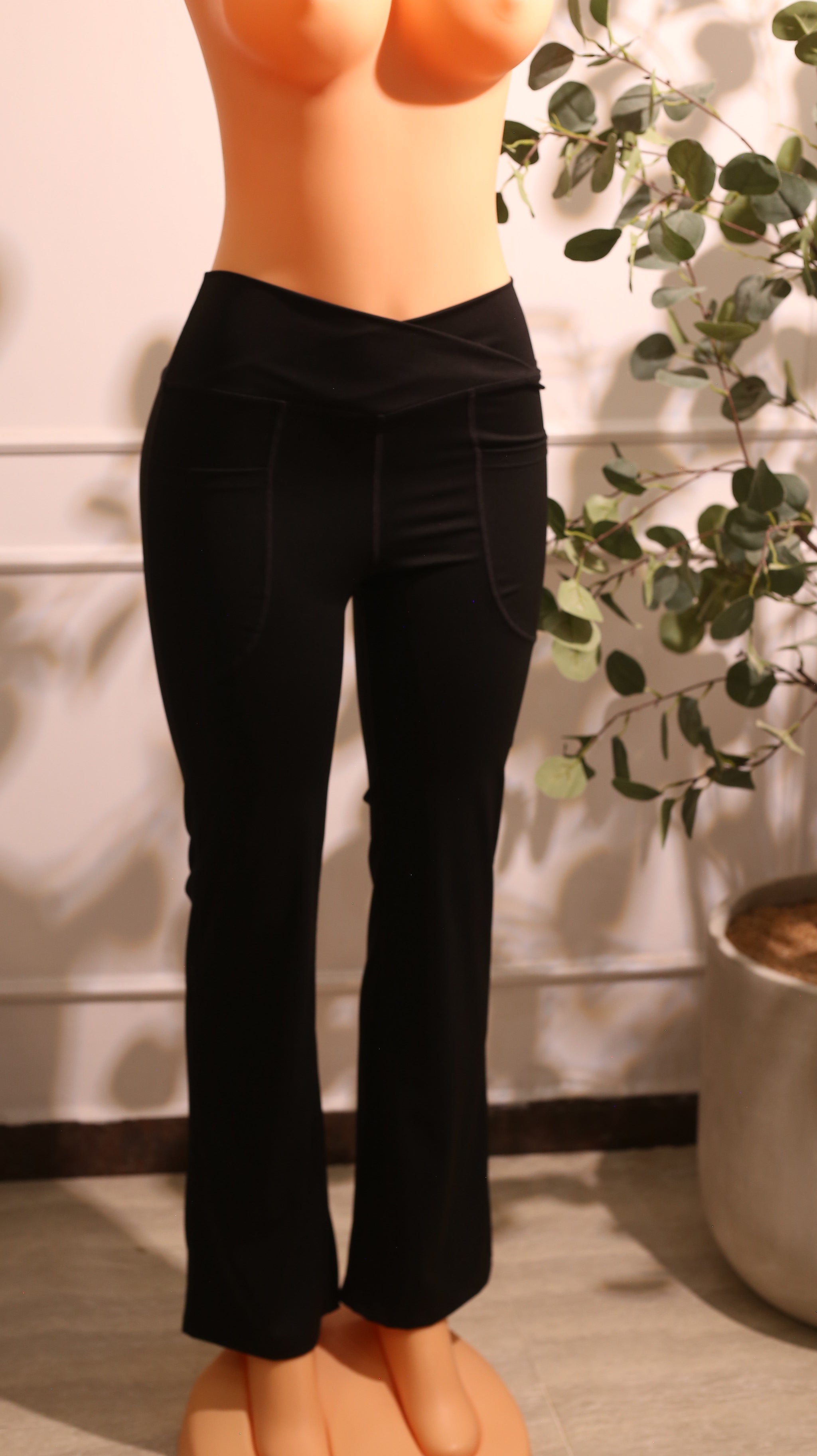 Pair Of Black High-Waisted Bootcut Yoga Pants With Pockets