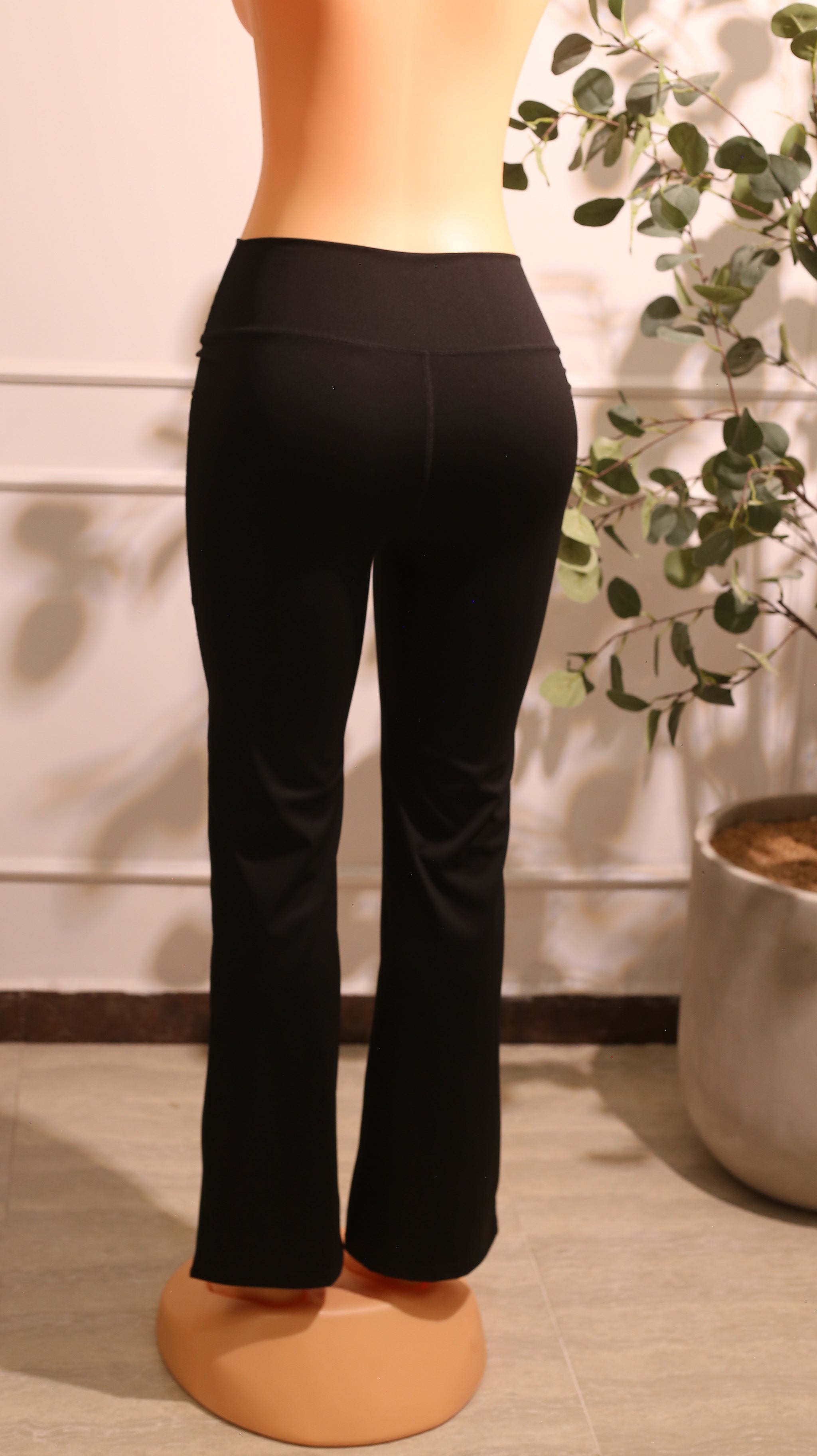 Pair Of Black High-Waisted Bootcut Yoga Pants With Pockets