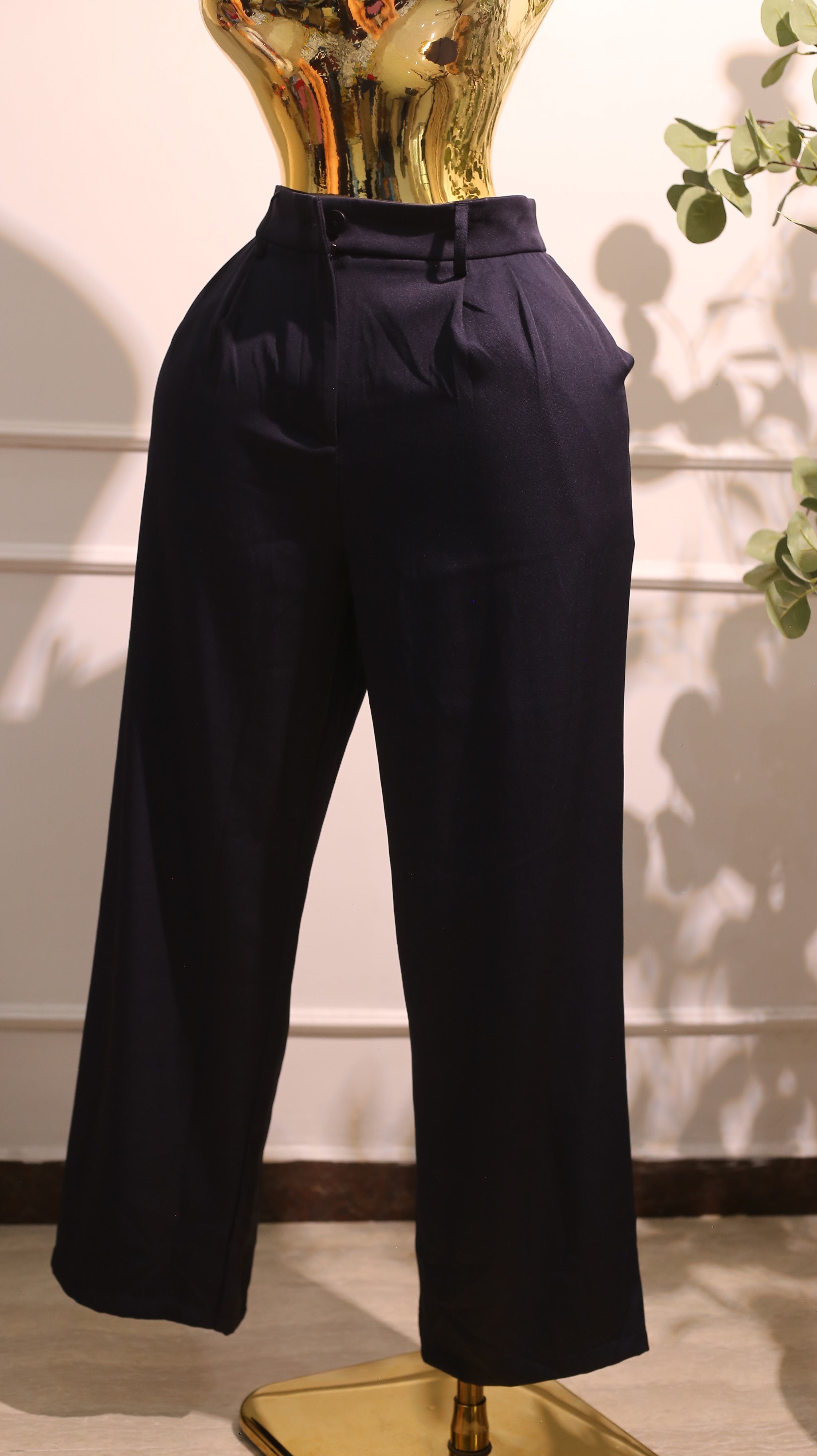 Pair Of High-Waisted, Wide-Leg Trousers, Possibly The Aritzia Effortless Pant In A Navy Blue Or Black Color