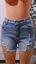 Pair Of Light Wash Ripped Denim Shorts With A Raw Hem