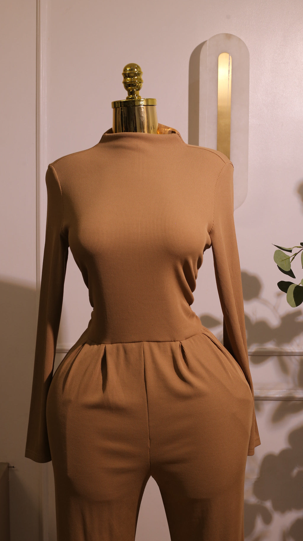 Long-Sleeved Mock-Neck Wide-Leg Jumpsuit In A Tan Or Camel Color, Made From A Soft And Stretchy Material