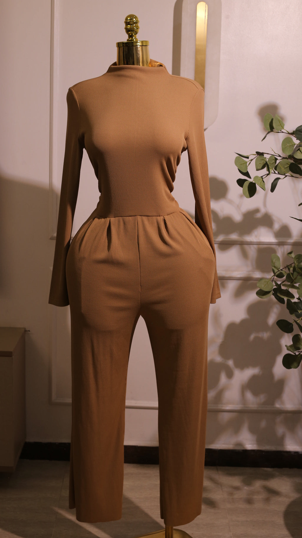 Long-Sleeved Mock-Neck Wide-Leg Jumpsuit In A Tan Or Camel Color, Made From A Soft And Stretchy Material